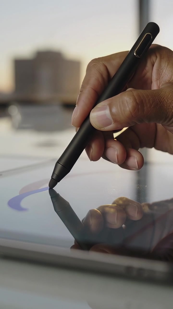 Vertical video: Drawing hand touching tablet screen with stylus at window, creating purple crescent