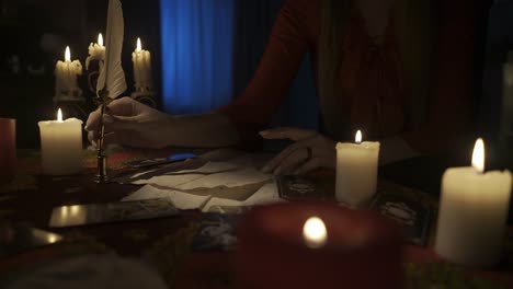 Woman performing a mystical ritual with candles and tarot cards