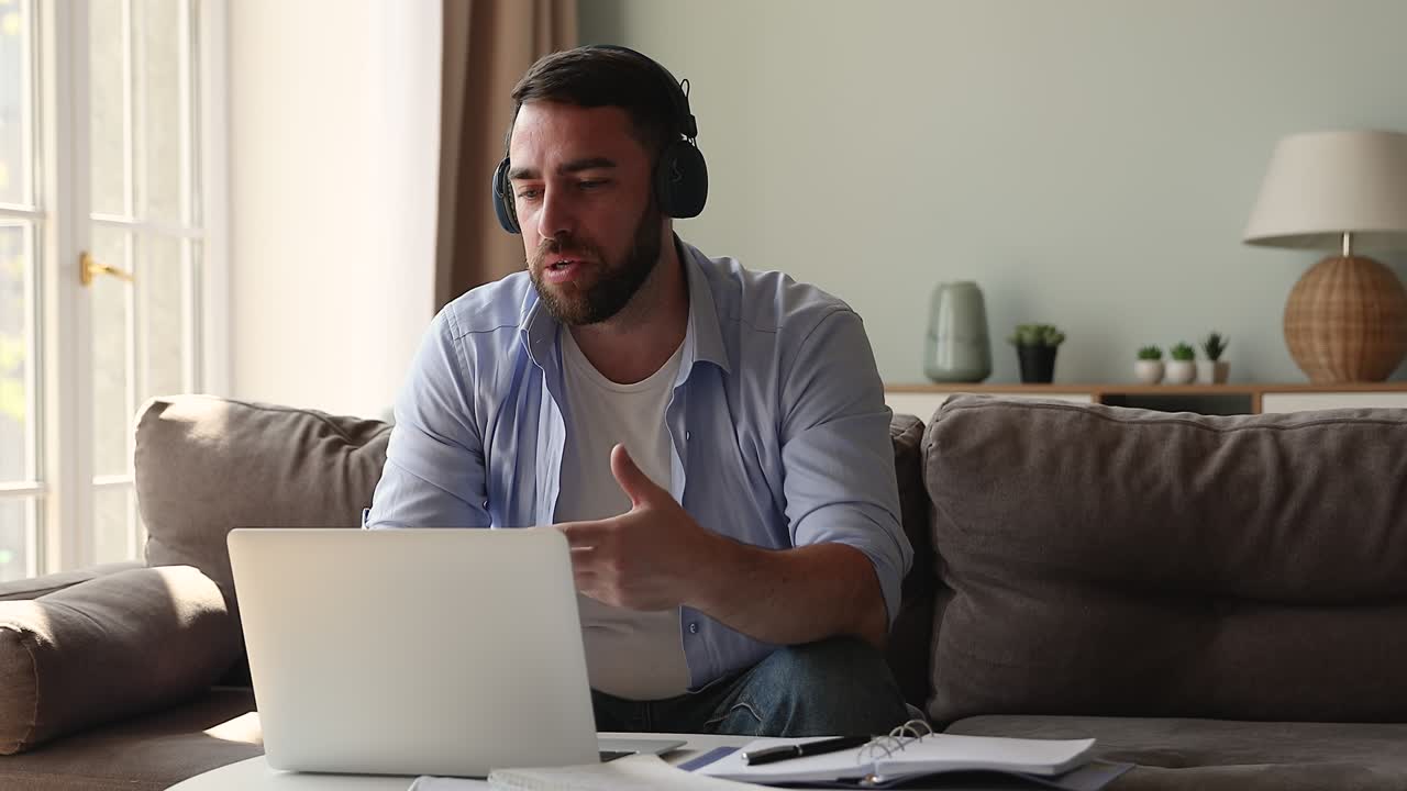 Male service line manager wear headphones answer customer question online