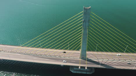 orbital aerial view bridge traffic above turquoise color ocean