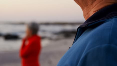 Senior-couple-standing-in-the-beach-4k