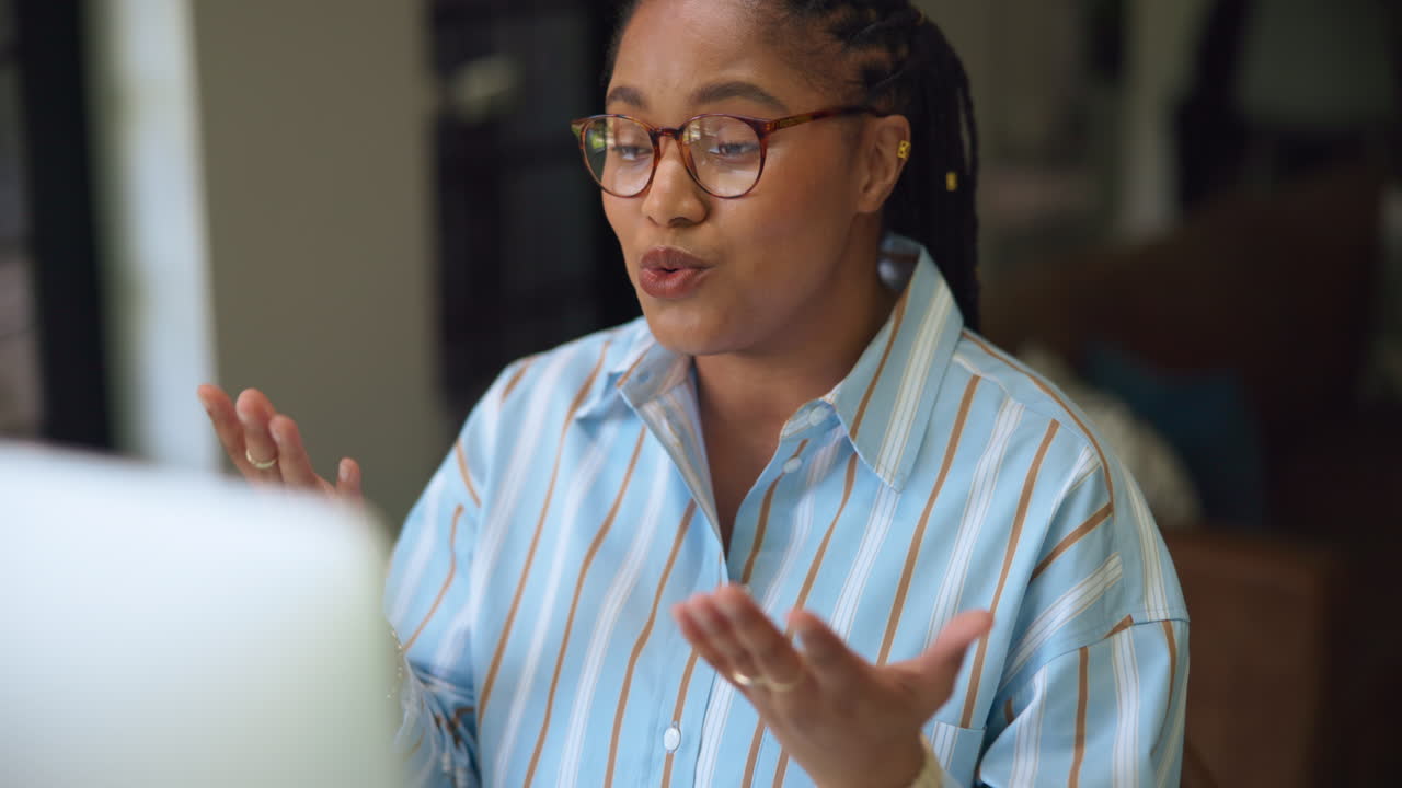 Young Woman Talking and Gesturing During an Online Video Call