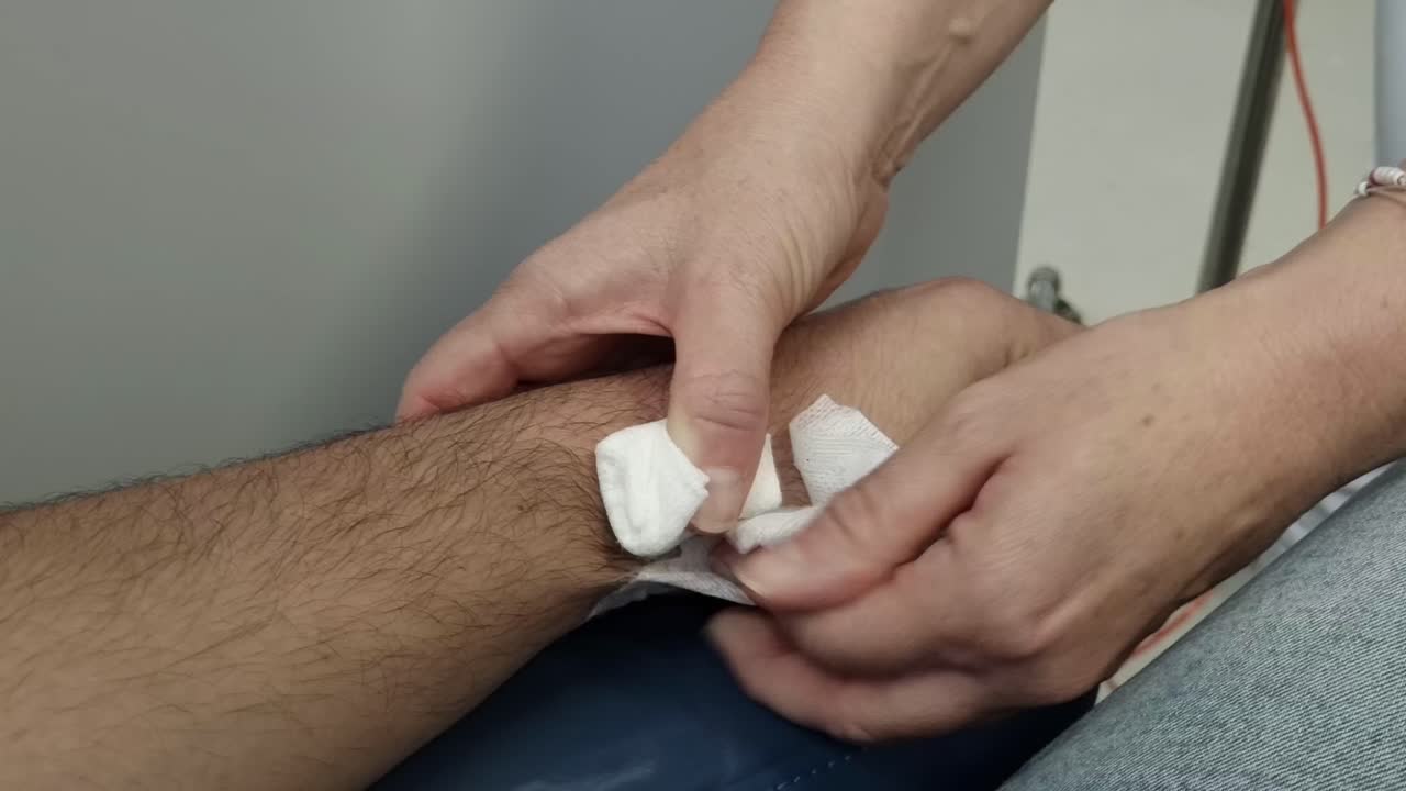 Hospital procedure: Removing needle from patient's arm after treatment