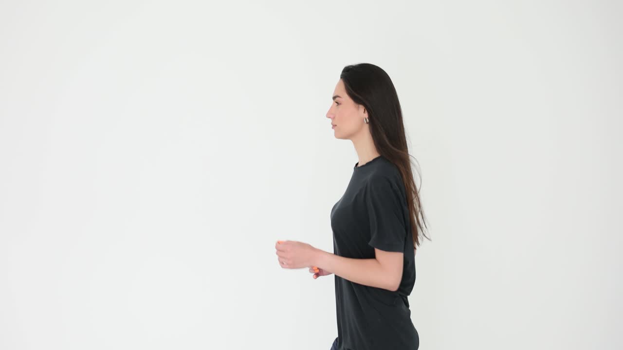 Young Woman Running in Place on White Background