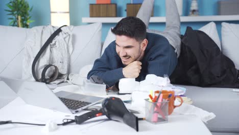 lazy and fun young man using laptop at home.