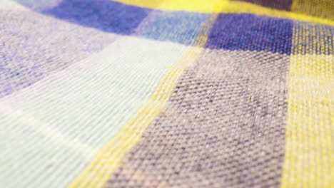 macro close-up of a blue and yellow, plaid shirt