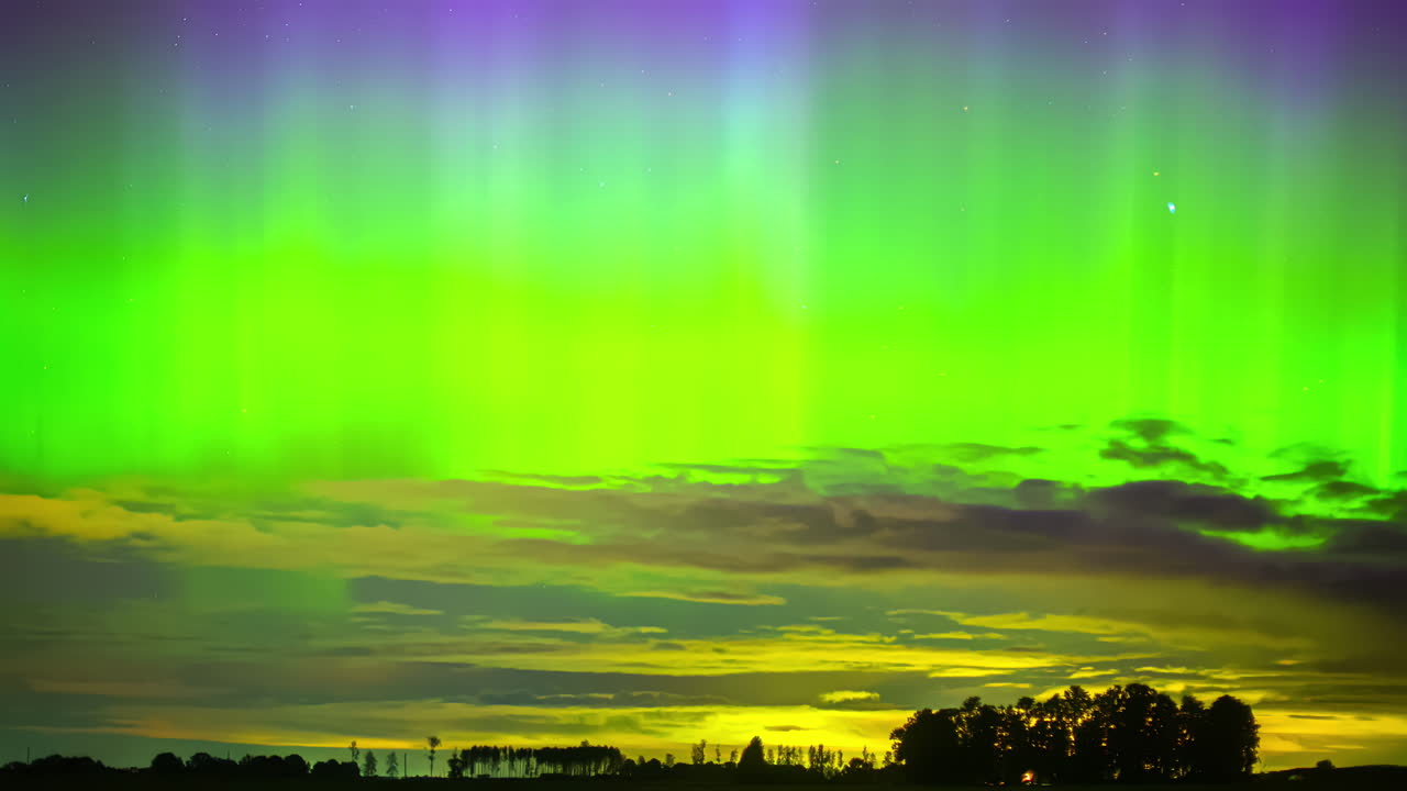 Vibrant Aurora Borealis lights up the night sky over a serene landscape