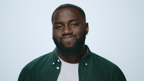 Portrait-of-serious-african-american-man-waving-head-no-at-camera-in-studio.