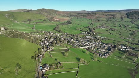 Wide-aerial-view-over-the-Peak-District-town-of-Castleton,-UK