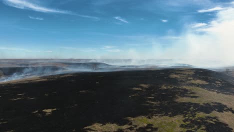 Flying-over-line-of-fire-to-reveal-completely-burnt-prairie-in-the-flint-hills-of-Kansas-after-controlled-burn