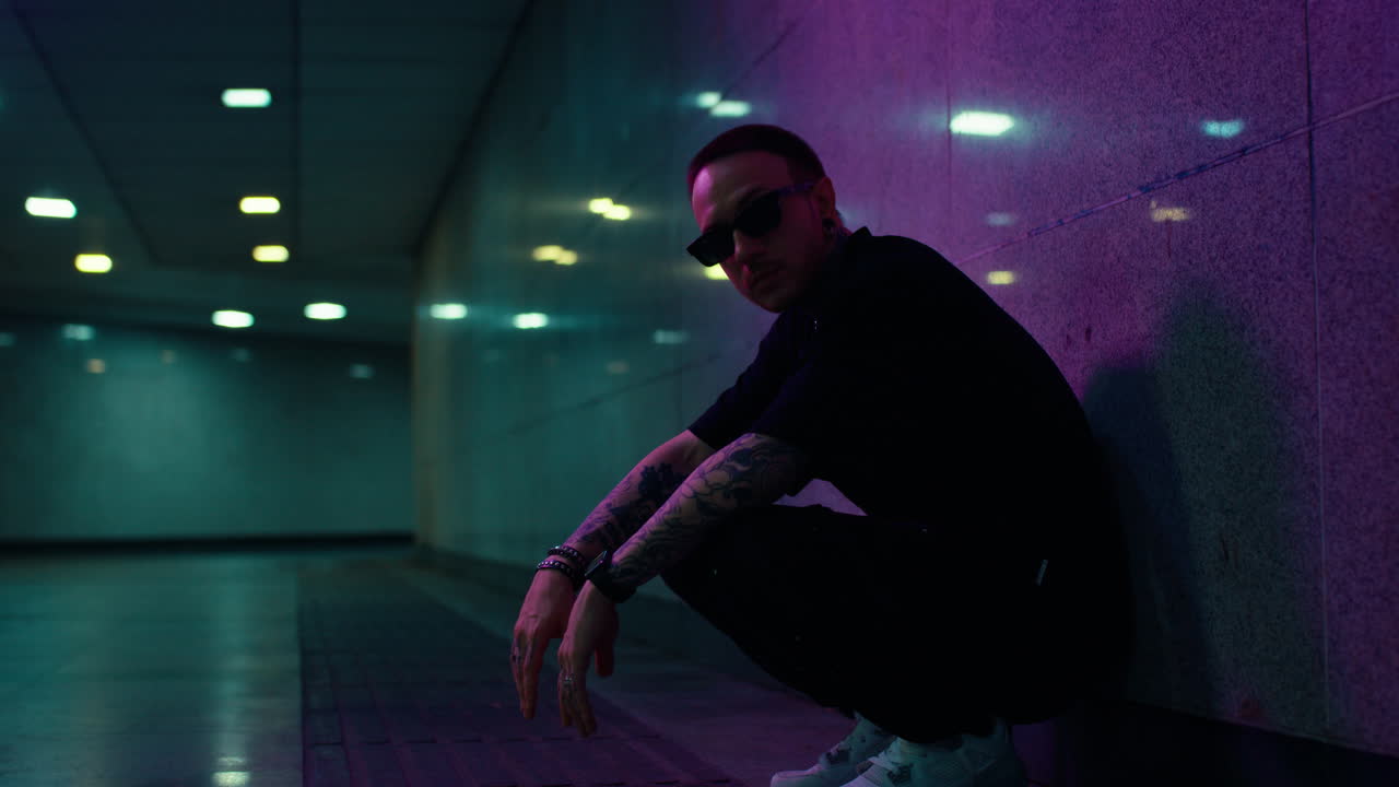 Stylish Man in Neon Tunnel