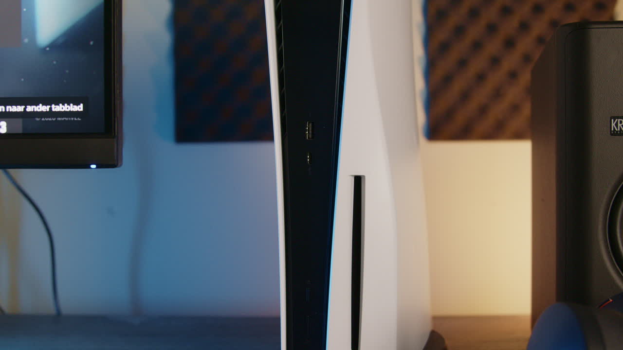 Gaming setup with PlayStation 5 and PS5 controllers in an RGB LED room at night, Slow reveal Close