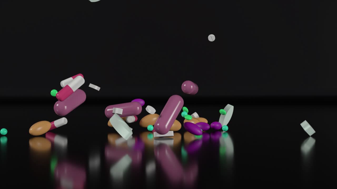 검은색 표면에 떨어지는 다채로운 알약