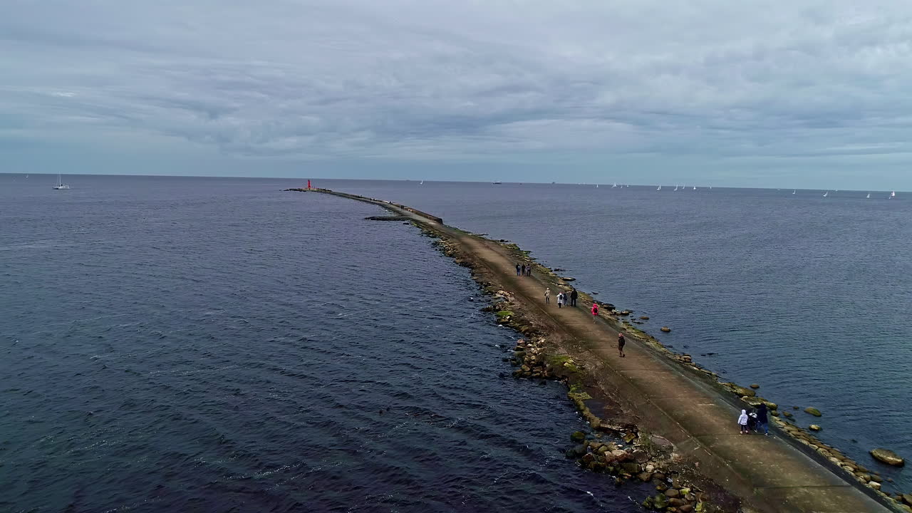 Concrete and rocks pier in blue sea water