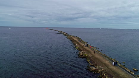 Concrete-and-rocks-pier-in-blue-sea-water