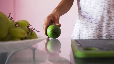 Man rolling mango for salad