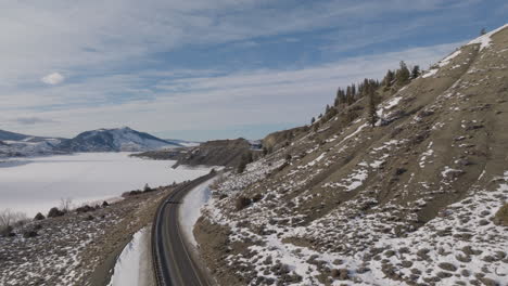 Aerial-shot-of-Cars-driving-down-a-moutain-road