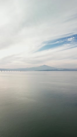 an reveal of the ocean bay between the richmond–san rafael bridge and point molate beach. filmed on a drone in 4k.