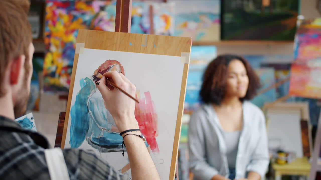 Artist painting a portrait in an art studio