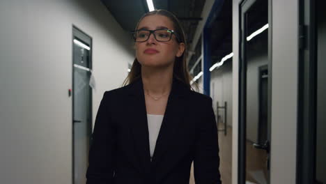 unhappy businesswoman throwing documents in office corridor. upset girl walking