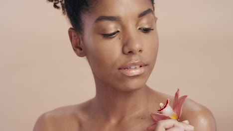 close-up-beauty-portrait-attractive-african-american-woman-touching-body-with-orchid-flower-caressing-healthy-skin-complexion-enjoying-gentle-fragrance-of-natural-essence-skincare-concept