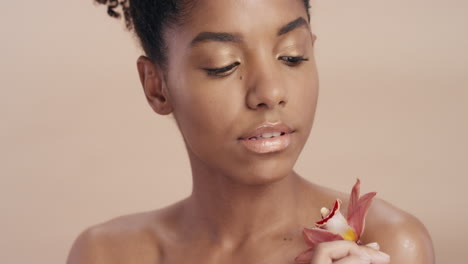 close up beauty portrait attractive african american woman touching body with orchid flower caressing healthy skin complexion enjoying gentle fragrance of natural essence skincare concept