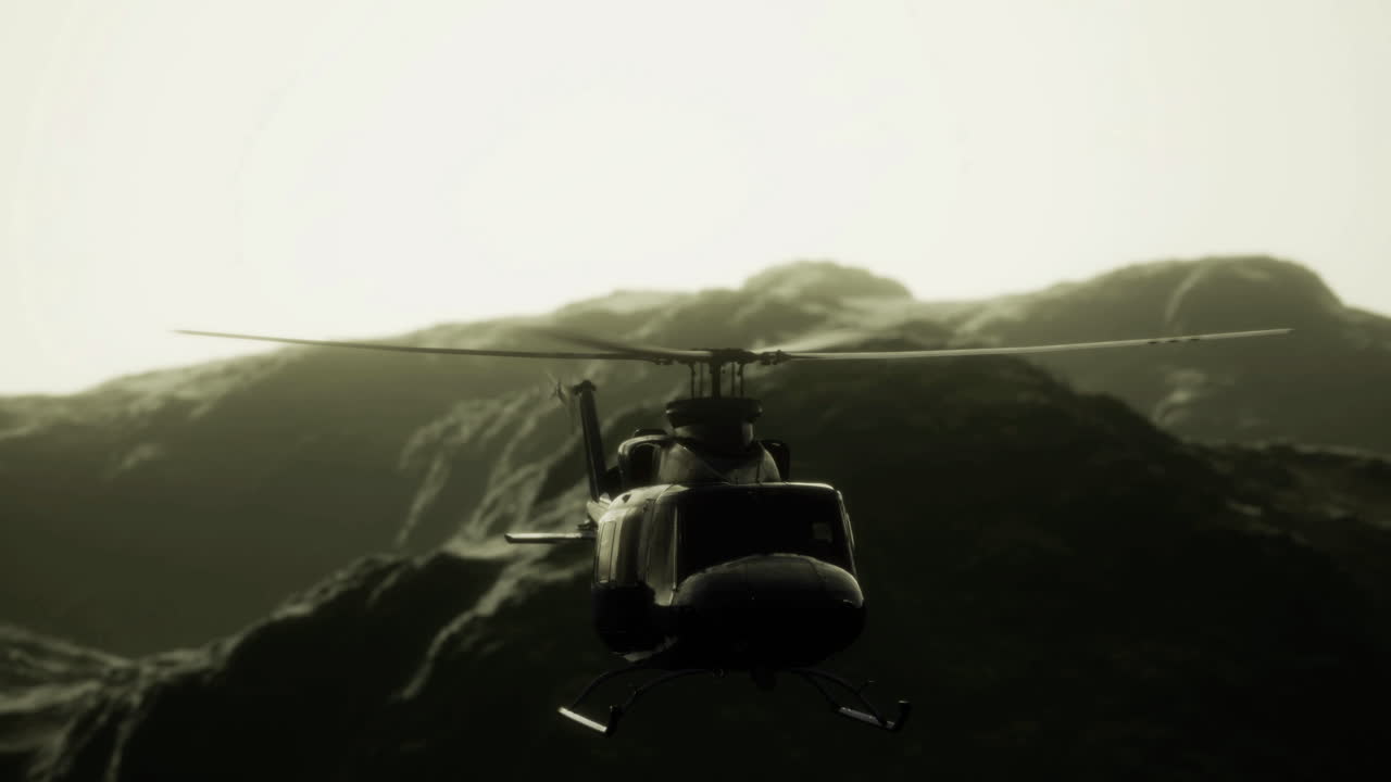 Helicopter approaches rugged mountains under a dramatic sky at dawn