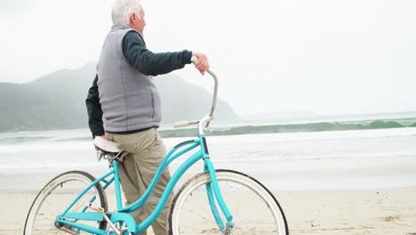 senior man standing with his bicycle