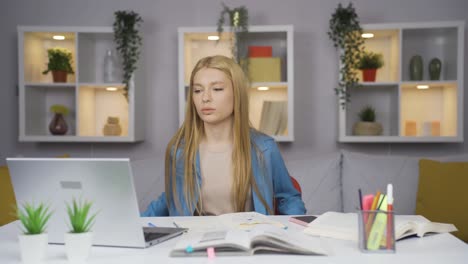 unhappy female student arriving at his desk.