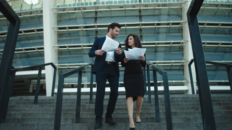 couple walking with documents in slow motion. couple discussing documents