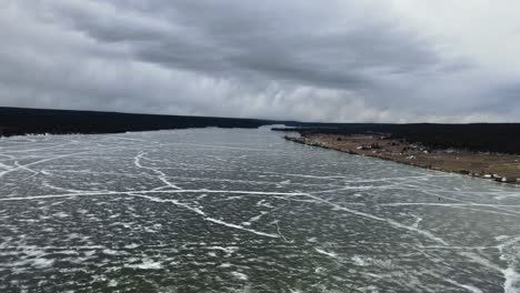 the aerial reveal of a frozen lac la hache lake in british columbia, canada