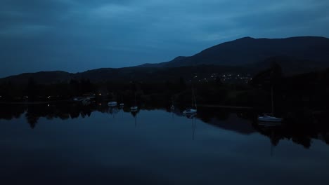 Flying-over-the-lake-in-the-night-in-Lake-District,-England