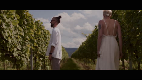 couple walking through a vineyard