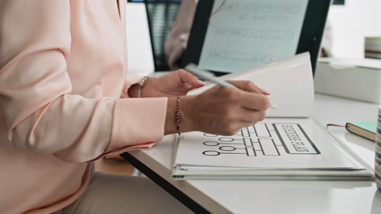 Female Marketer Making Notes on Paper during Meeting at Office