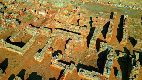 ancient megaron ruins in nikolaos, greece, showing old stone structures, aerial view