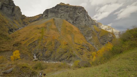 untouched natural landscape in mountainous canyon with couple hiking on trail