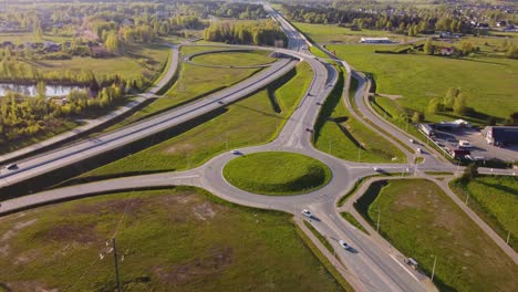 traffic circulation at katlakalns roundabout from above in latvia. aerial pullback shot