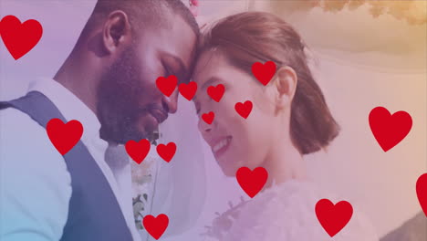 embracing and smiling, couple with red hearts animation floating around them