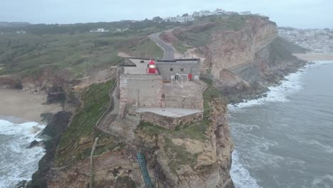 an iconic place on the atlantic coast, the mecca of big-wave surfing. view of nazare's lighthouse in zon north canyon, place with the biggest waves in europe, nazare, portugal