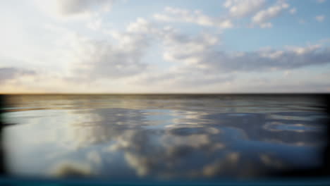 calm ocean water with blue sky and clouds