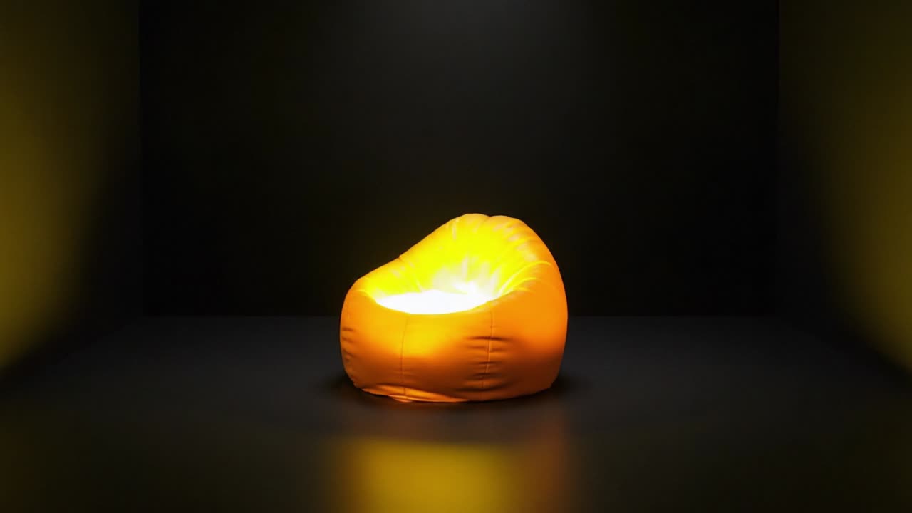 A Cozy Glow: The Transformation of a Soft, Yellow Bean Bag Chair Illuminated in a Dark Room, Highlighting its Comfort and Unique Design