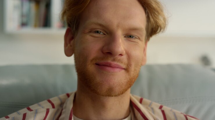 Closeup ginger guy posing at home weekend. Dreamy man relaxing on cozy sofa
