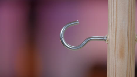 Ring-a-Bull-retro-classic-pub-game-suspended-ring-swinging-onto-a-hook,-slow-motion,-close-up