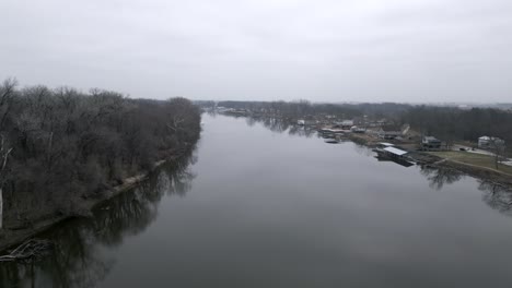 flying over river through hazy sky, aerial drone