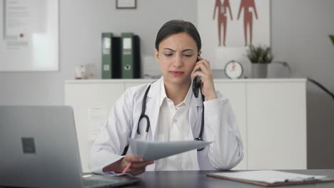 Indian-female-doctor-explaining-medical-report-to-patient-on-call