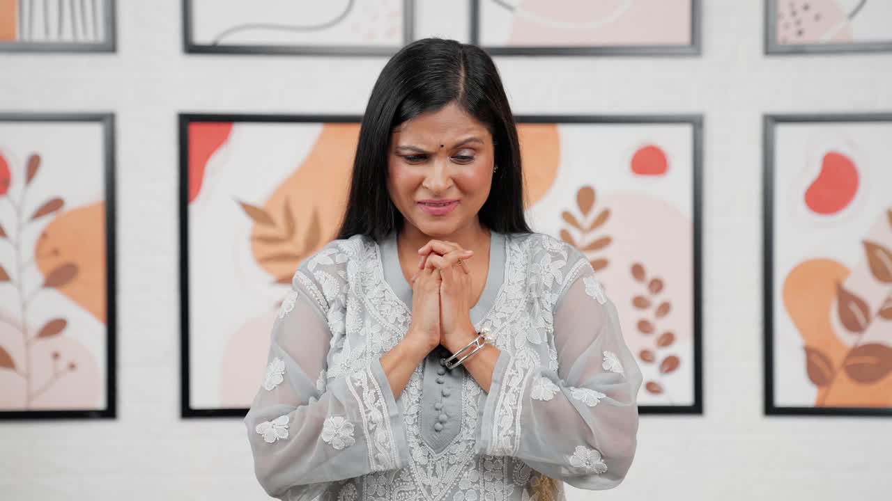 Sad Indian woman praying to god