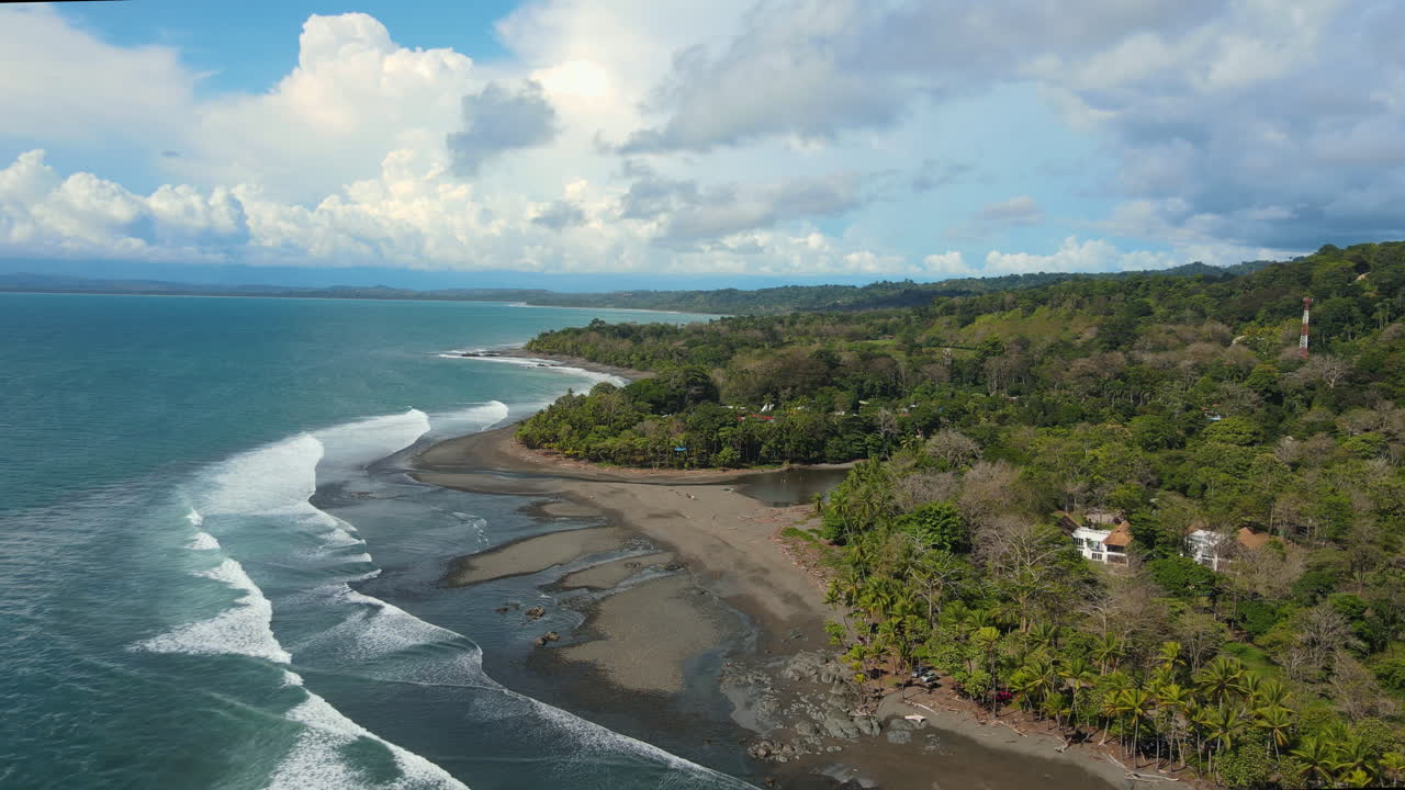 Costa Rica's coastal landscape: green hills, rocky shores, blue waters.