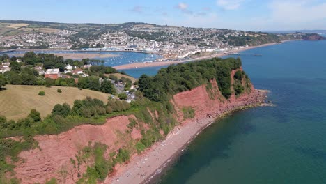 aerial flight over ness cove beach, buildings on top and beautiful teignmouth port in background