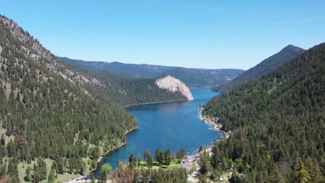 sunlit bliss: revel in the beauty of paul lake in kamloops, encircled by majestic forest-covered mountains