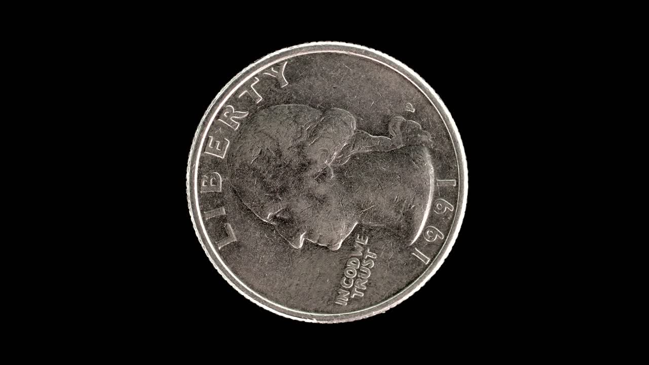 United States 1991 quarter dollar coin obverse with Washington portrait and motto rotating on black background